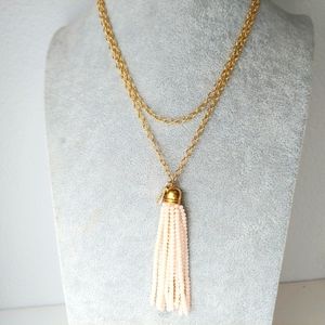 34 inch Bourbon and Bowties necklace, gold tone chain with pink tassel.